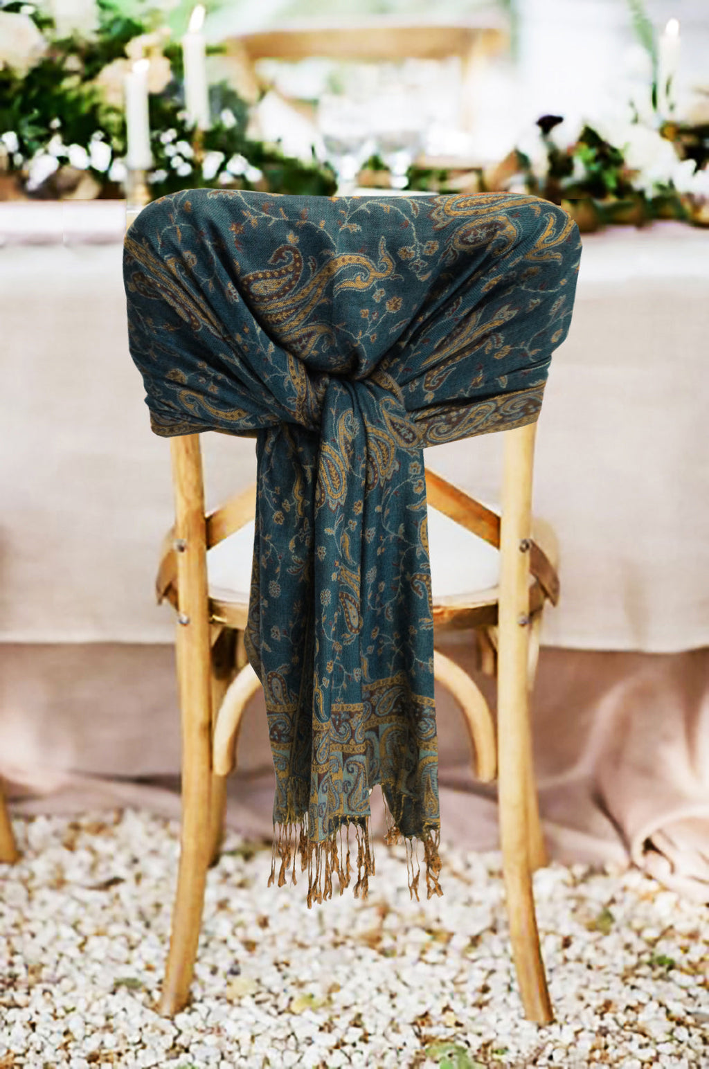 Teal paisley double-layer pashmina shawl with fringe ends, draped over chair