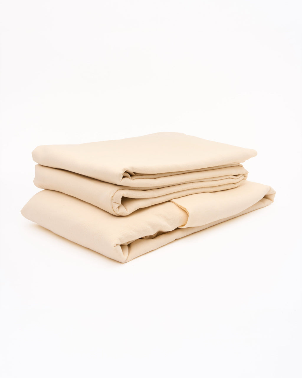 Cream sheet set with neatly folded fitted and flat sheets, layered for storage