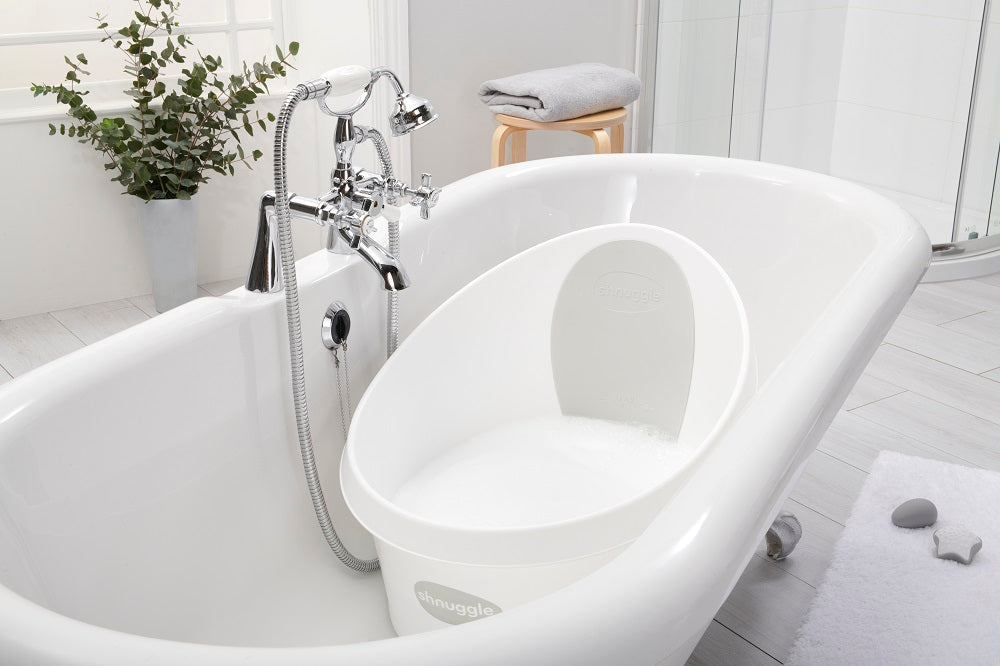 Toddler bath tub with white backrest, shown empty in a bathroom