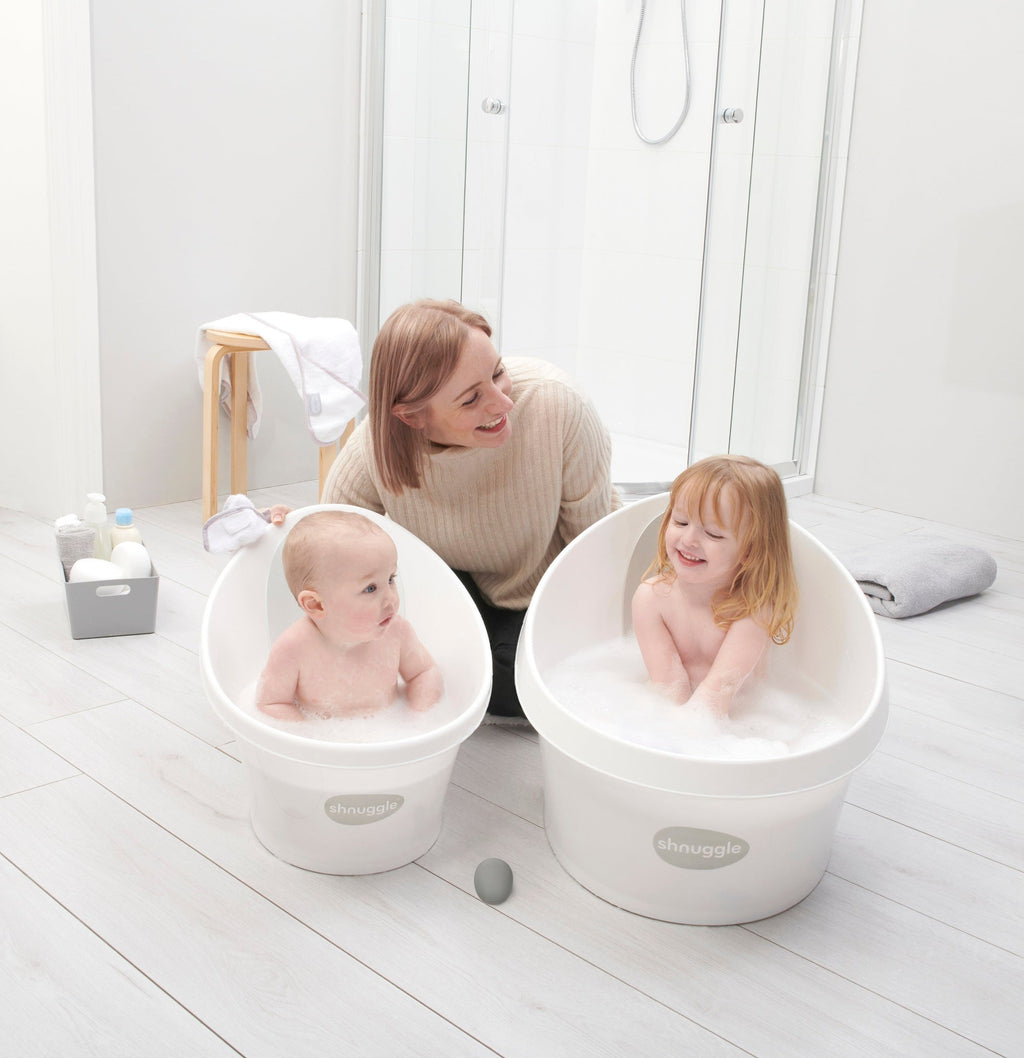 Toddler bath tub set: two white tubs with children seated and splashing