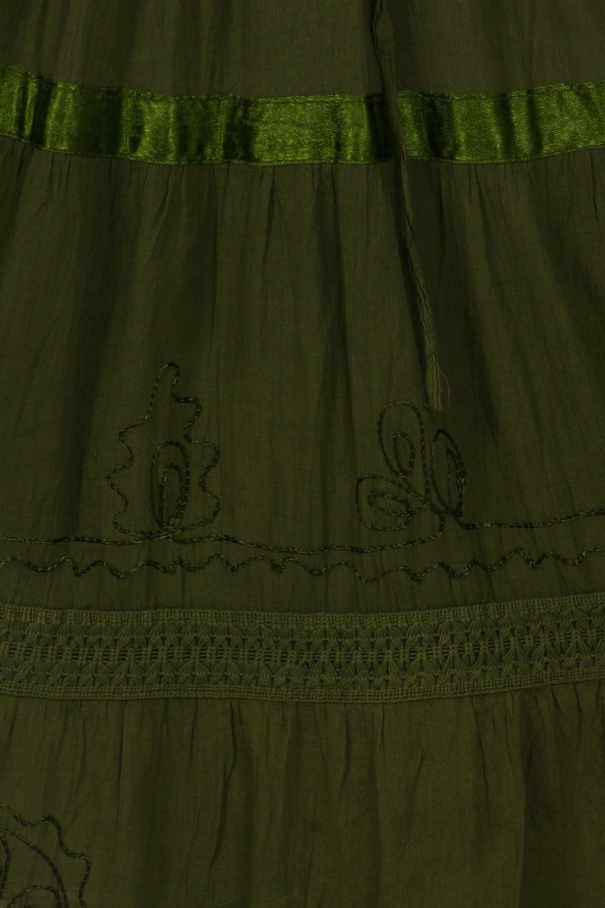Olive green tiered cotton skirt with embroidered motifs and lace-edged hem band