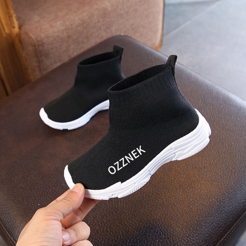 Kids slip-on sneakers, black knit upper and white cushioned sole with elastic collar