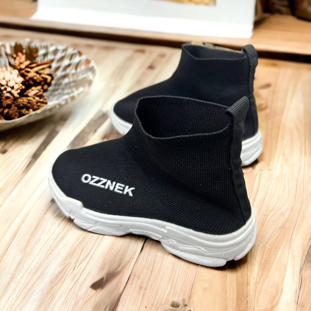 Kids slip-on sneakers, black knit upper with white sole and OZZNEK logo on side