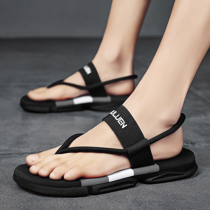 Black ankle wrap slide sandals with white stripe detail and cushioned slip-resistant footbed