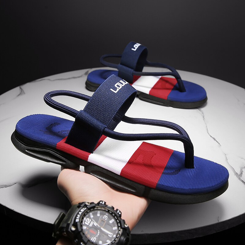 Blue ankle wrap slide sandals with red and white stripes, adjustable strap, grippy sole