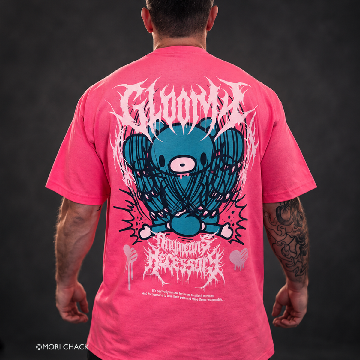 Coral pink T-shirt with large back graphic of teal monster and drip pattern
