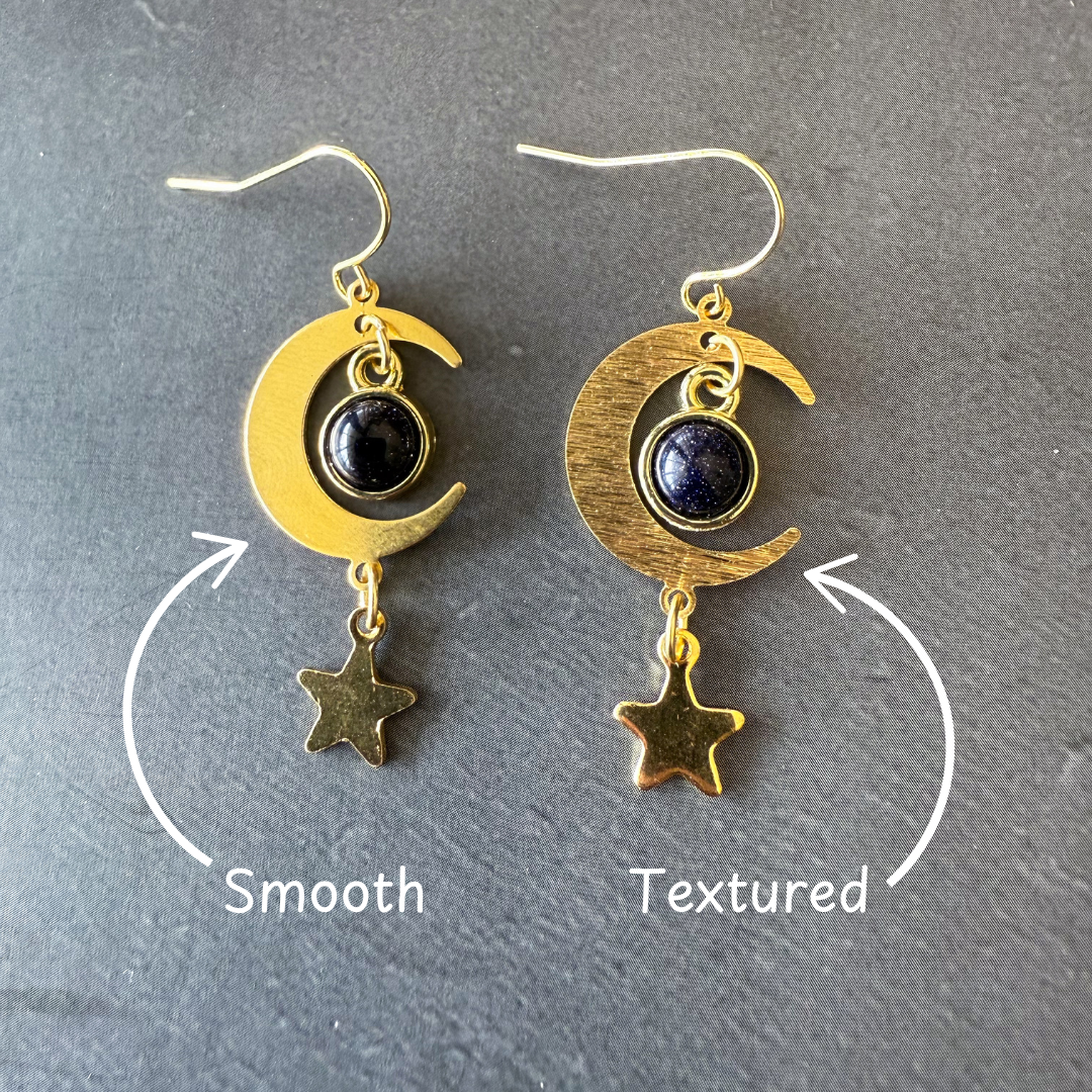Crescent moon earrings set: one smooth and one textured gold, dark blue stones, star dangles