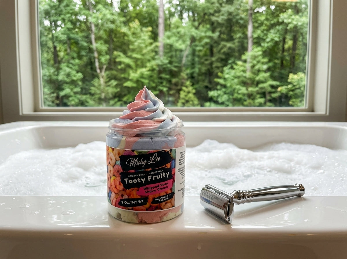 Whipped soap and shave cream jar on bathtub ledge with razor nearby