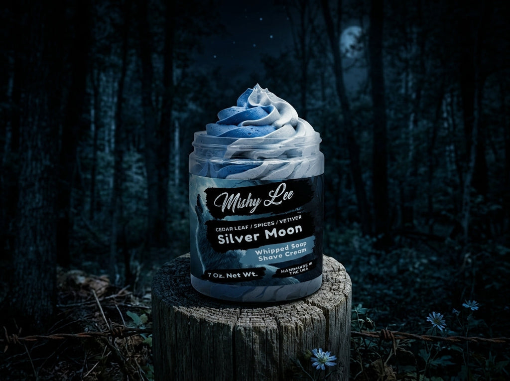 Mushy Lee Silver Moon whipped soap and shave cream jar on a dark outdoor log