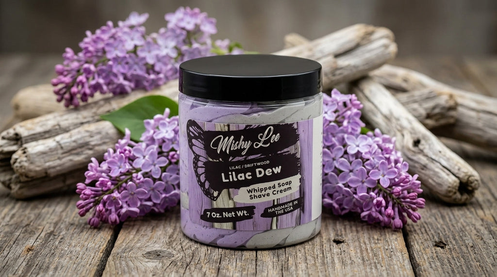 Mishy Lee Lilac Dew whipped soap and shave cream jar on wood with purple flowers