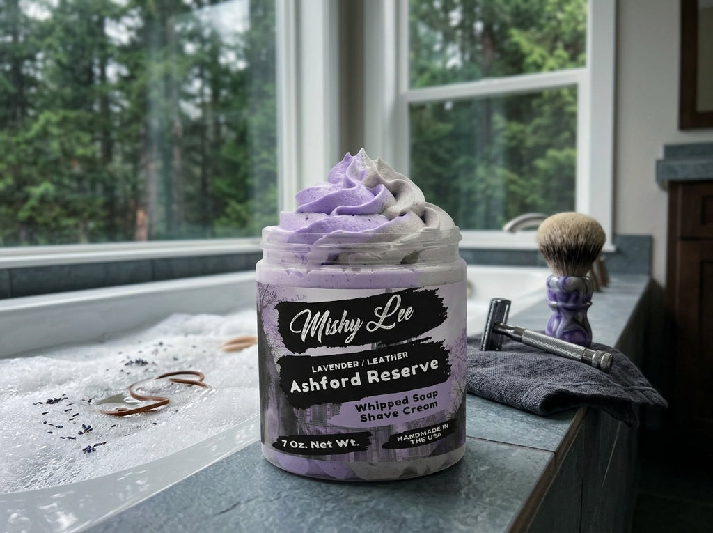 Purple whipped soap/shave cream jar on bathroom counter with shaving brush and towel