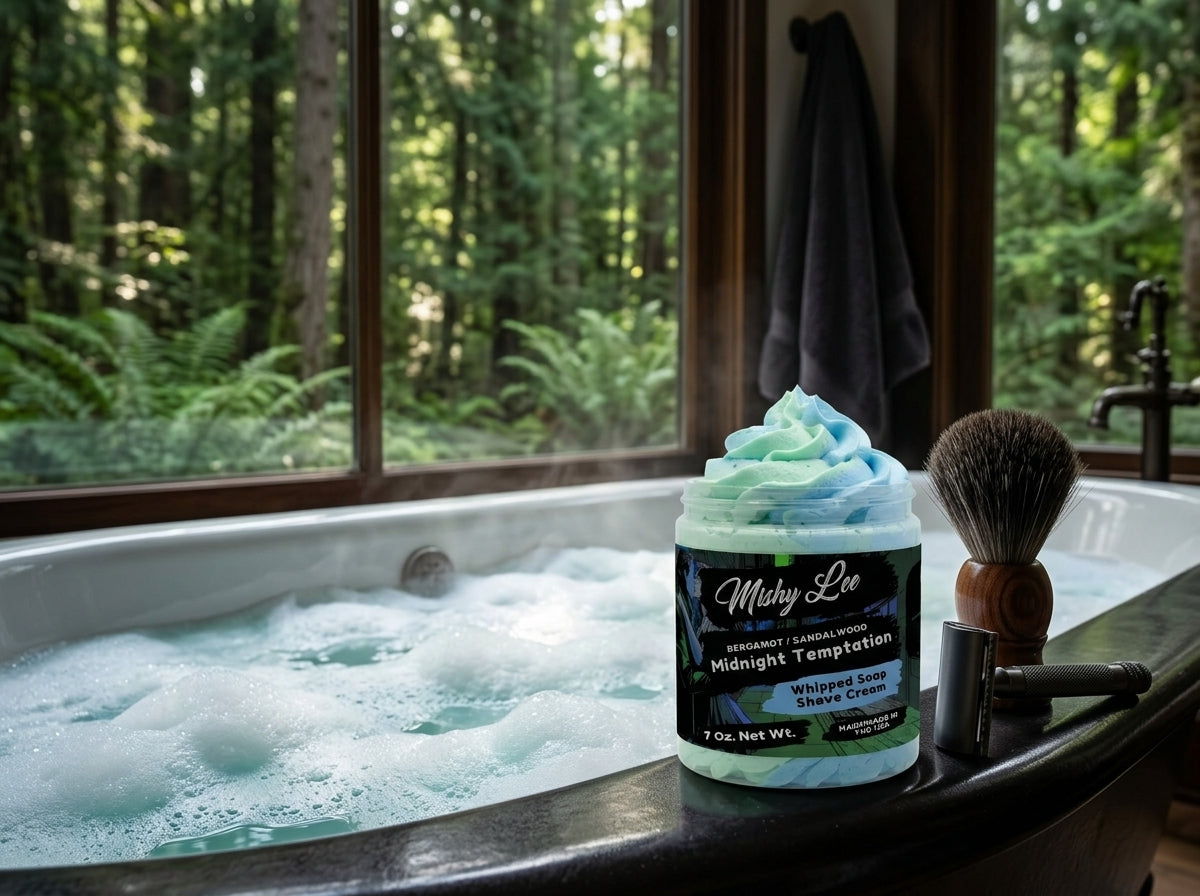 Mishy Lee whipped shave cream jar beside a shaving brush in a bathtub setting
