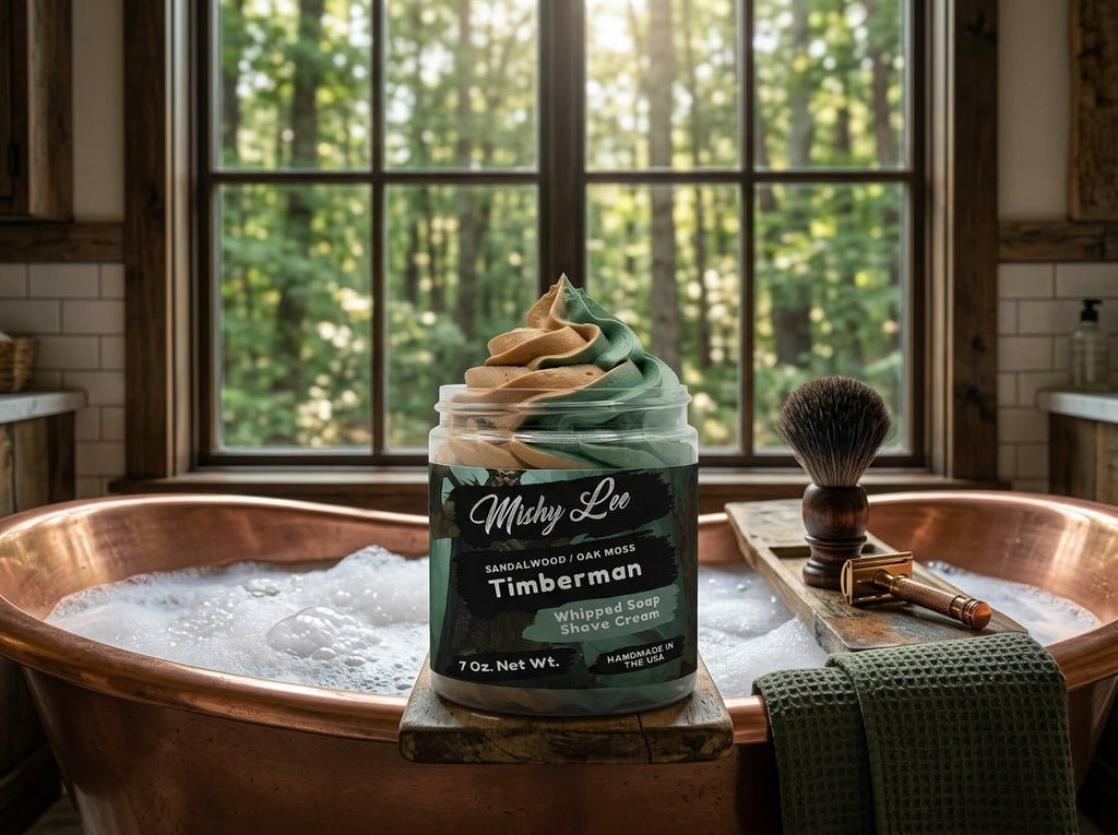 Men's whipped soap and shave cream jar beside a metal shaving bowl and brush