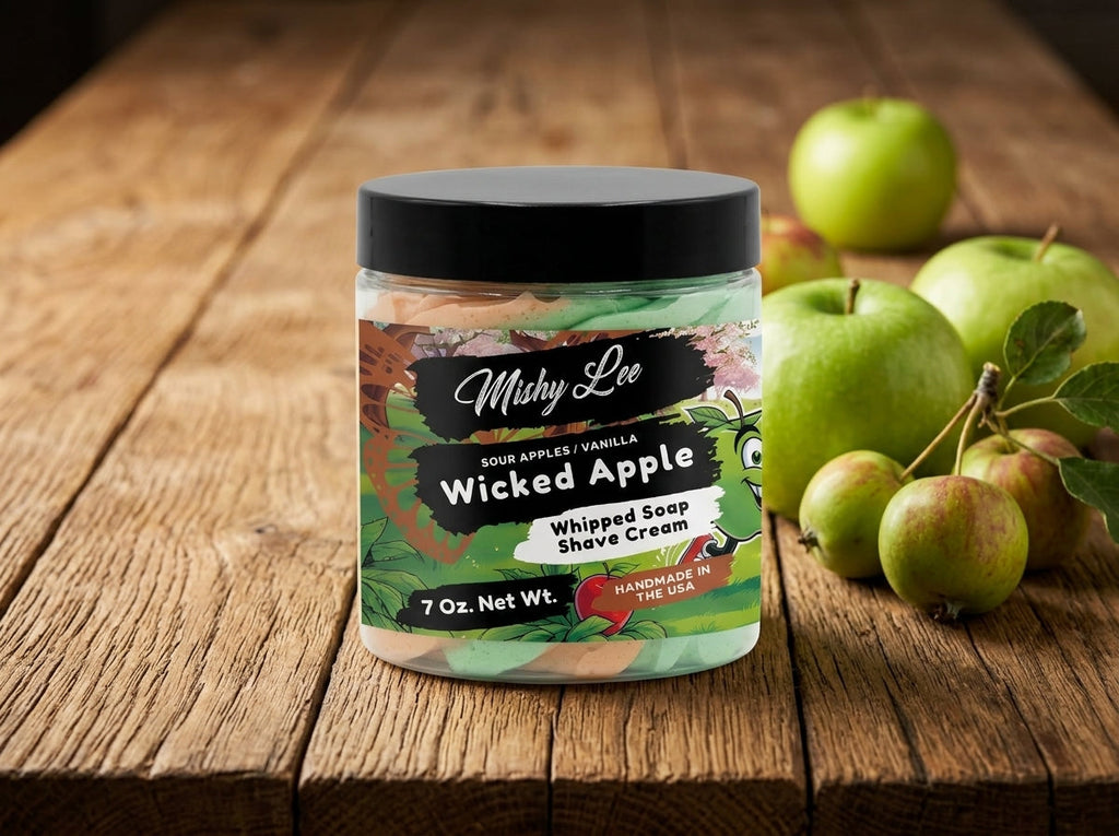 Whipped soap and shave cream jar with black lid on a wood surface, green label.