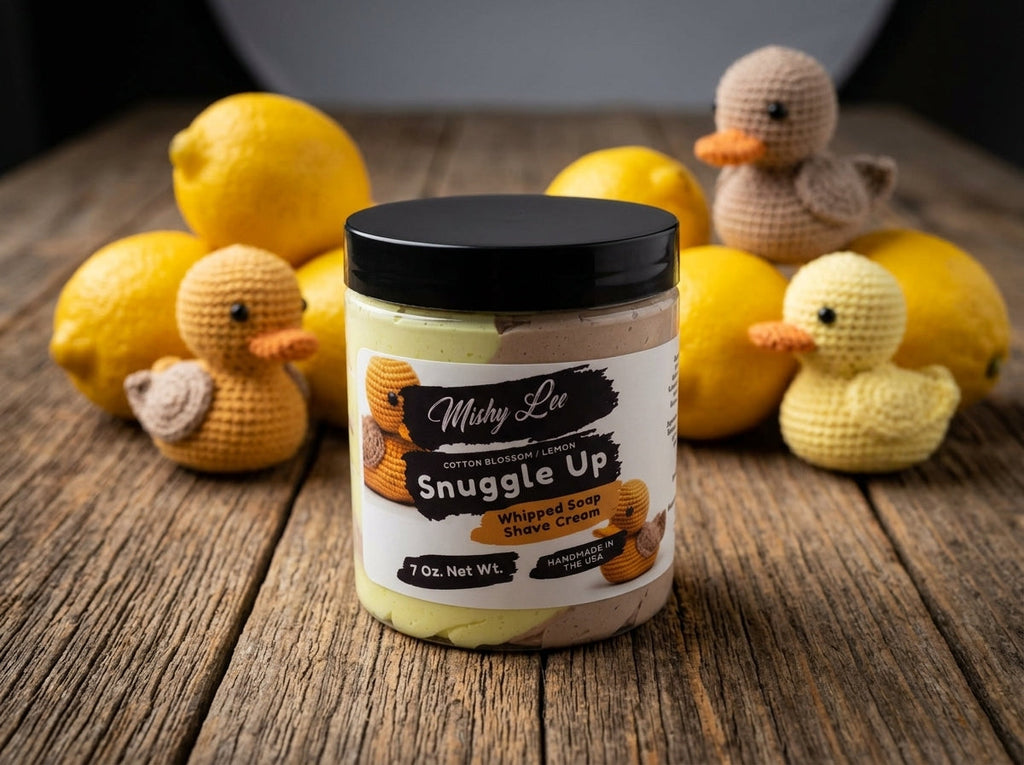 Whipped soap and shave cream jar on wooden surface with small fruit figurines