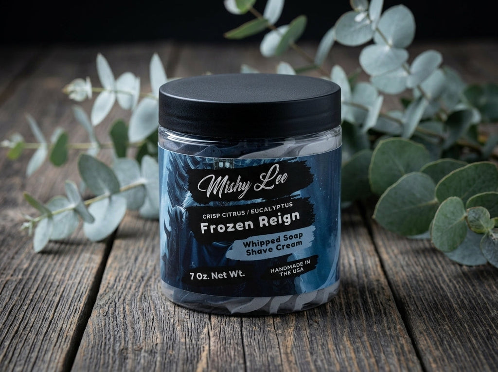 Whipped soap shave cream jar on wooden surface with navy label and whipped swirl