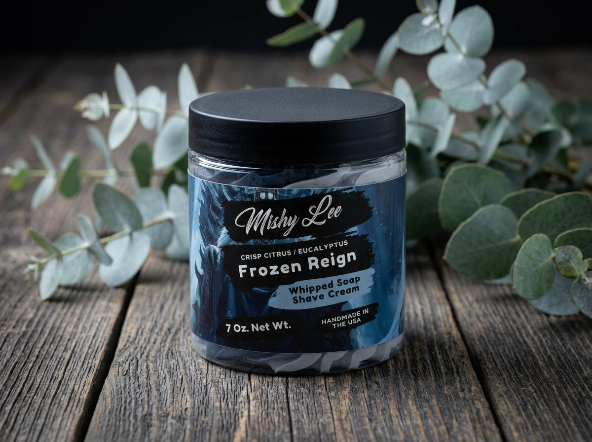Whipped soap shave cream jar on wooden surface with navy label and whipped swirl