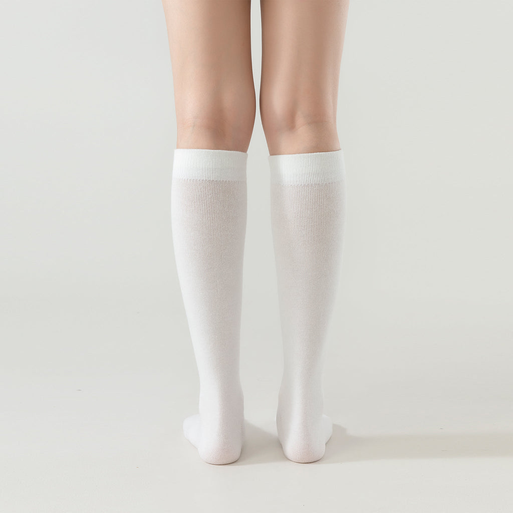 Pair of cream white crew socks with ribbed ankle and smooth toe