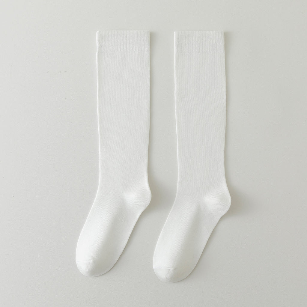 Two cream white crew socks side by side, smooth knit finish