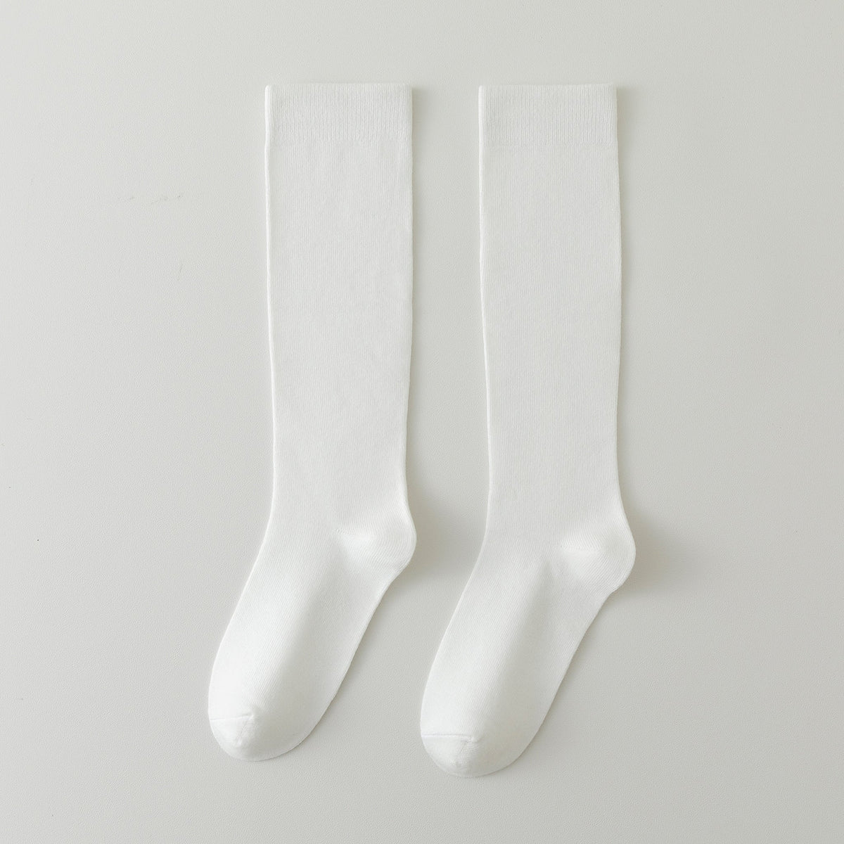 Two cream white crew socks side by side, smooth knit finish