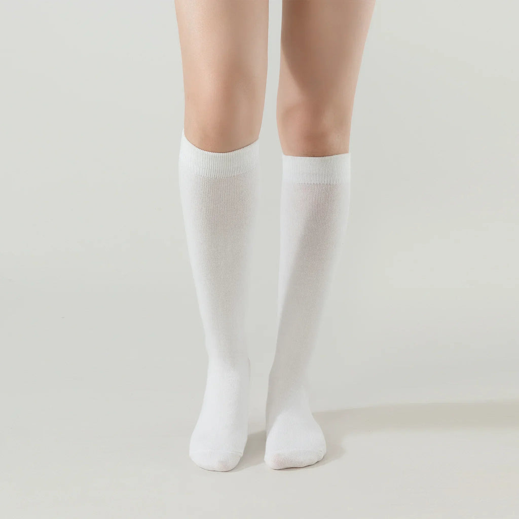 Cream white crew socks, ribbed cuffs and full-length knit