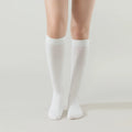 Cream white crew socks, ribbed cuffs and full-length knit