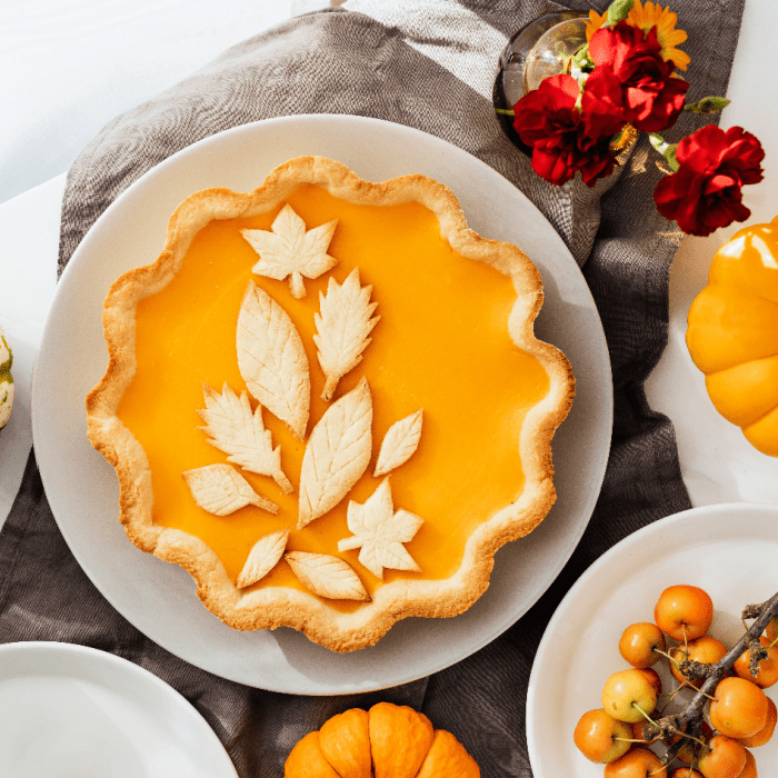 Pumpkin-shaped orange fragrance wax melt with leaf-shaped cutouts in the center