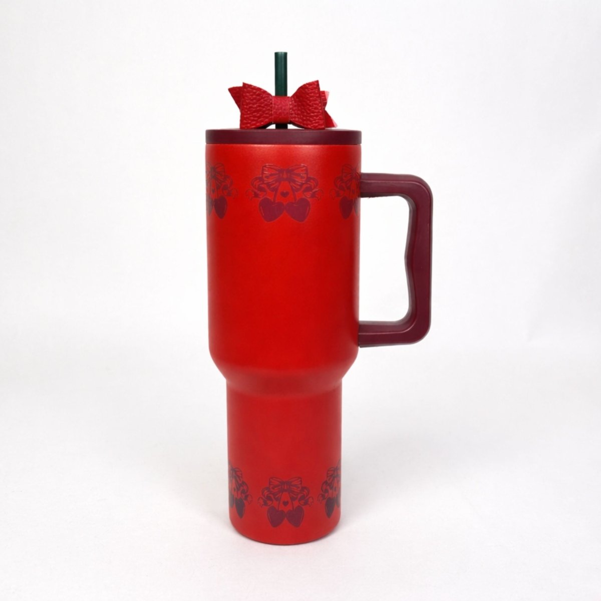 Red cherry tumbler with handle and decorative bow on top