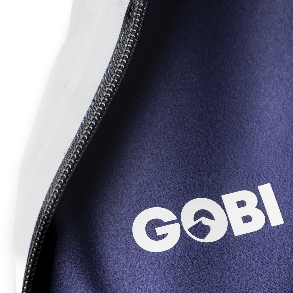 Close-up of navy vest side zipper seam and GOBI logo