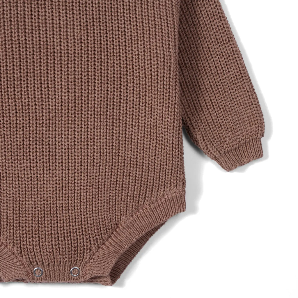 Mocha chunky knit baby romper with long cuffed sleeves and ribbed hem.
