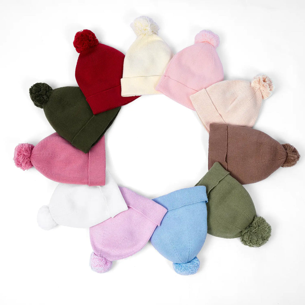 Assorted knit baby pom beanies; sage green option shown among others