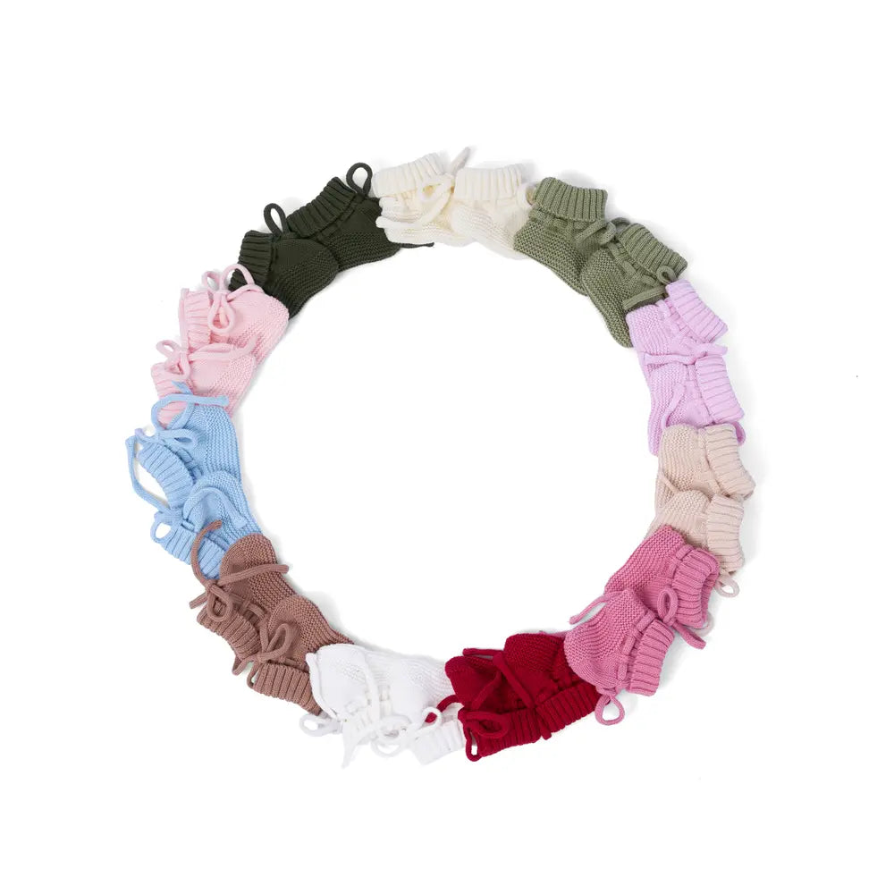 Circular display of assorted knitted baby booties in various colors