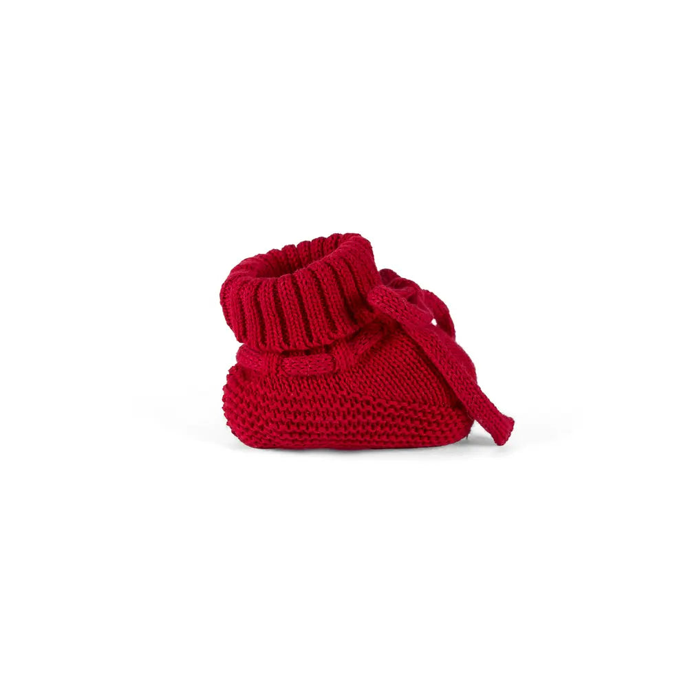 Red knitted baby bootie with bow tie, ribbed cuff, and rounded toe