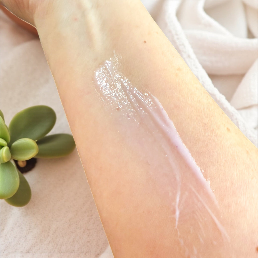 Tallow lotion on forearm with visible moisturizing sheen