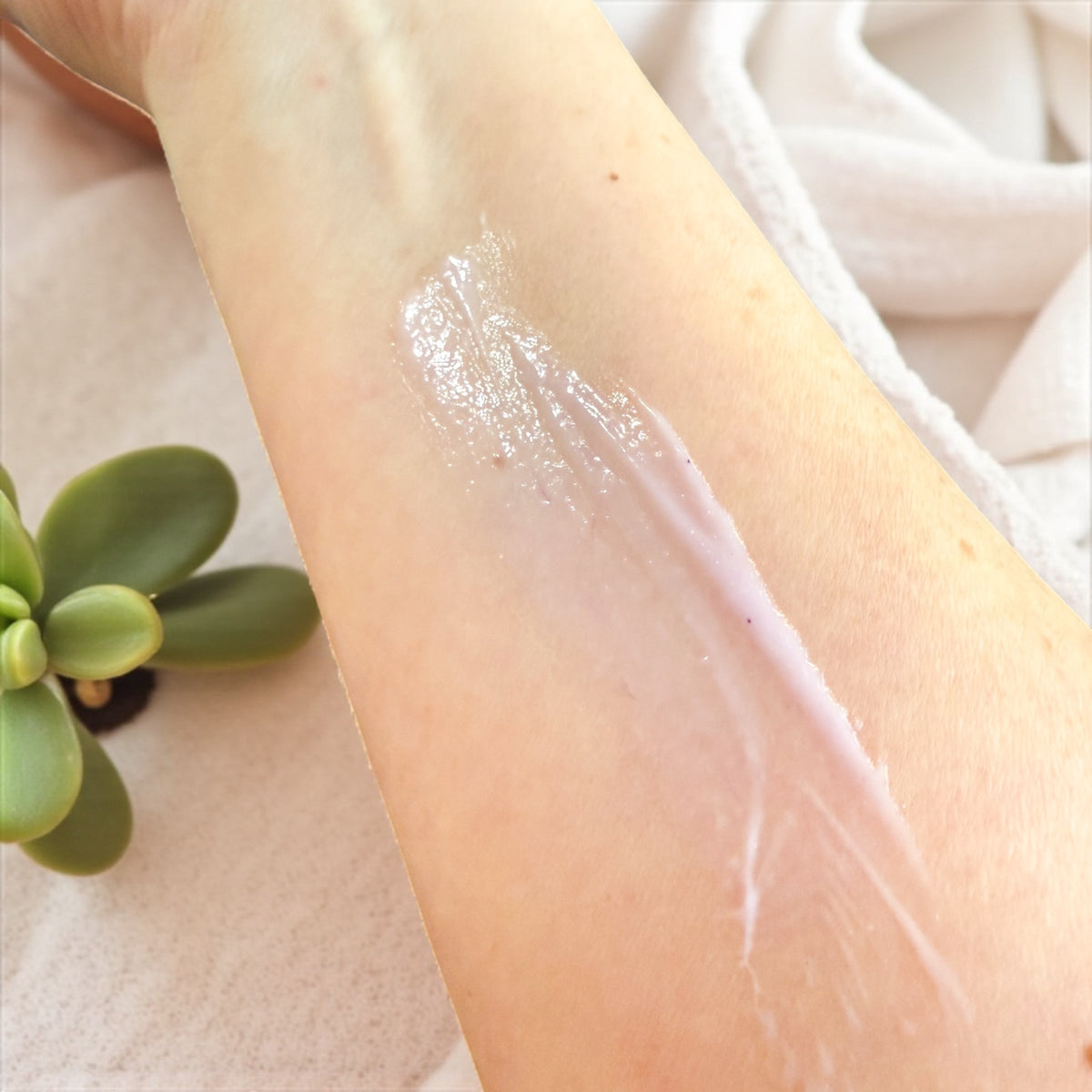 Tallow lotion on forearm with visible moisturizing sheen