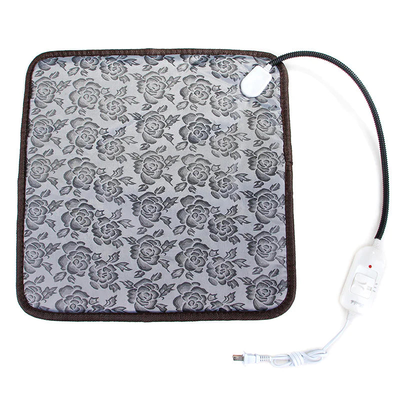 Gray heated pet blanket with rose pattern, brown edge trim, and power cord