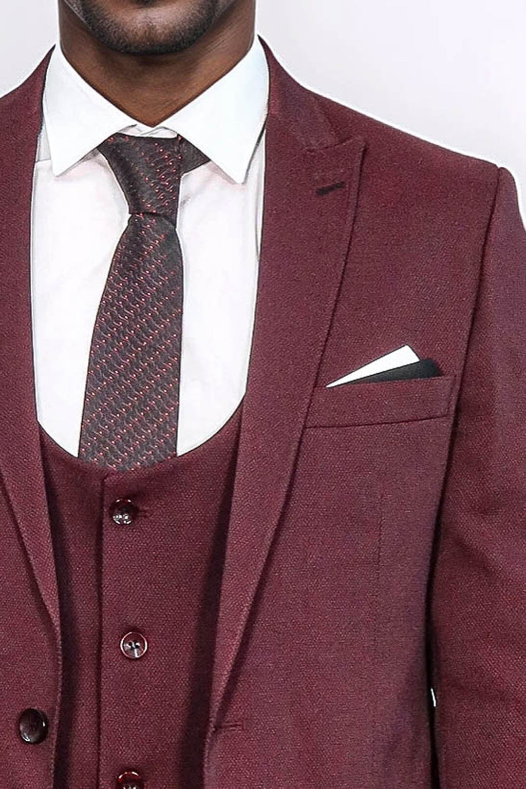 Burgundy suit jacket with patterned vest, dress shirt, tie, and pocket square
