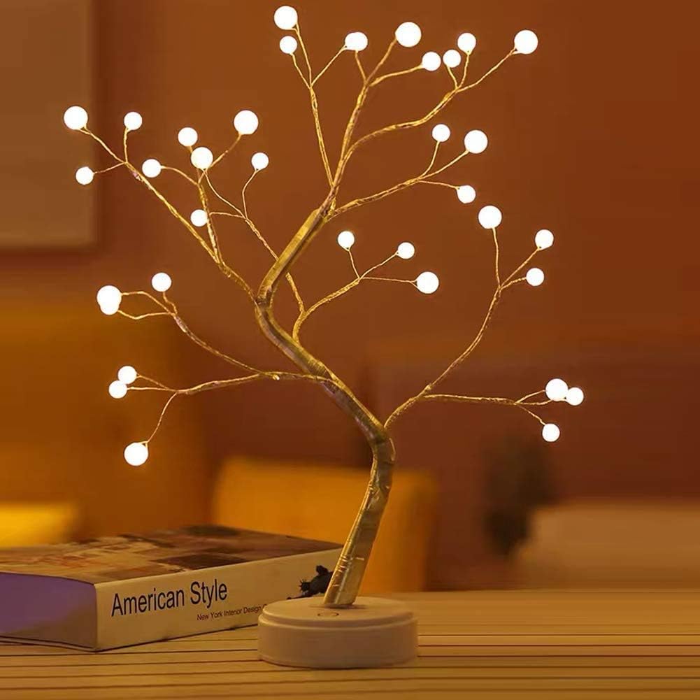 Battery LED tree lights with warm white bulb points on gold branch, round base.