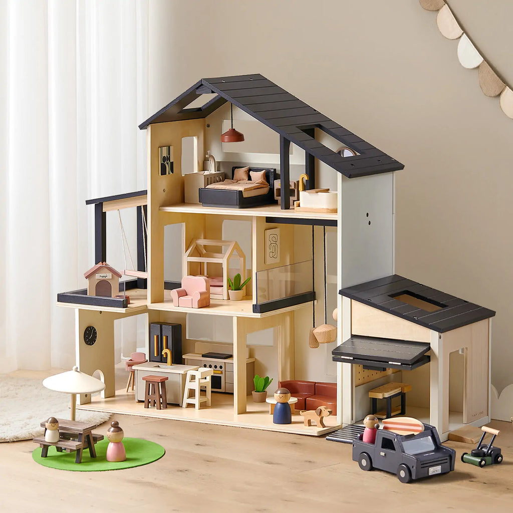 Dollhouse and garage playset with open floors, dark awning, and mini accessories