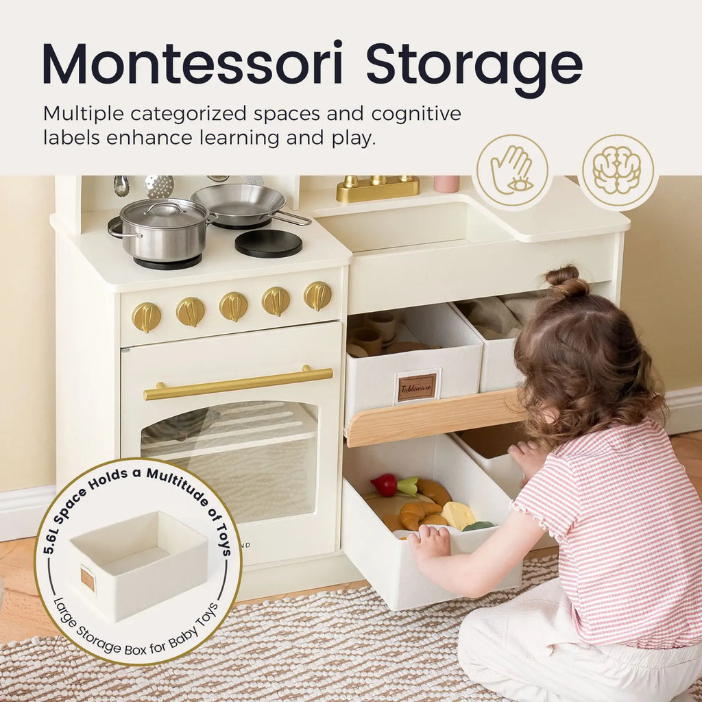 Wooden play kitchen with labeled storage shelves and toy pots, cream with gold hardware