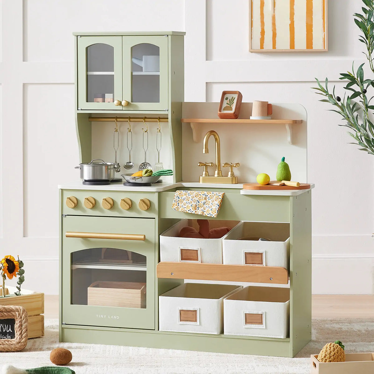 Wooden play kitchen with storage, sage green cabinet with gold faucet and toy cookware