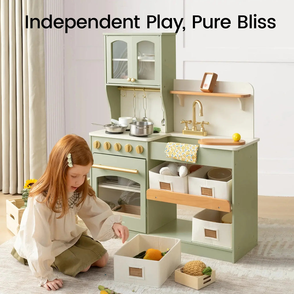 Sage green wooden play kitchen set with stove, sink, and storage bins