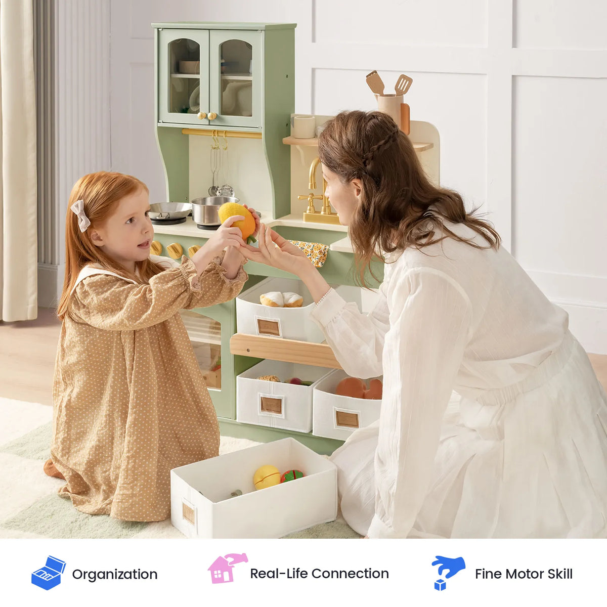 Sage green wooden play kitchen with storage drawers and doors