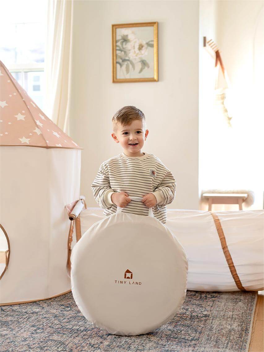 Play tunnel ball element with light tan and white fabric and stitched handle loop