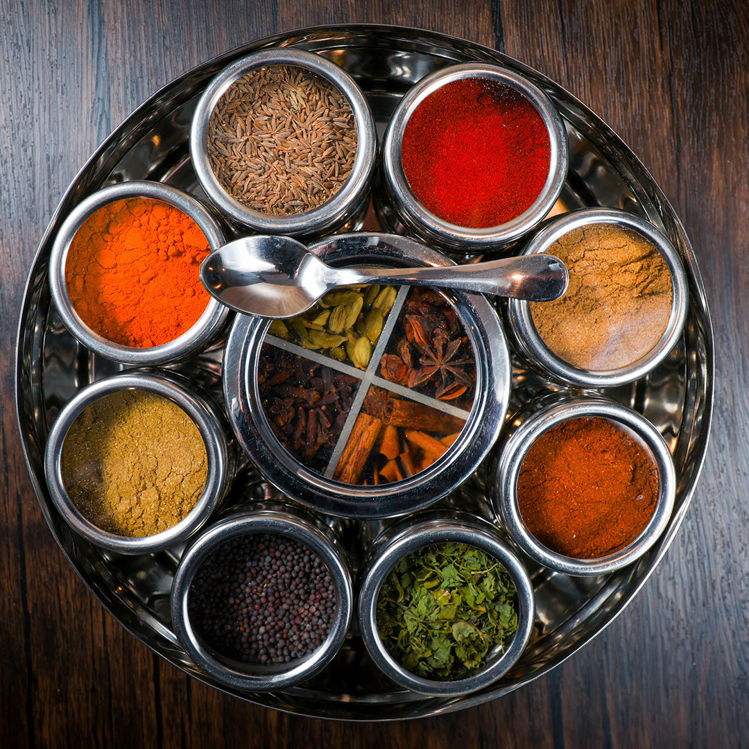 Indian spice wheel stainless tray with assorted spice compartments and serving scoop