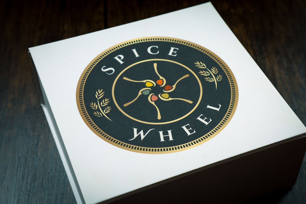 Spice wheel gift box with gold logo on white lid