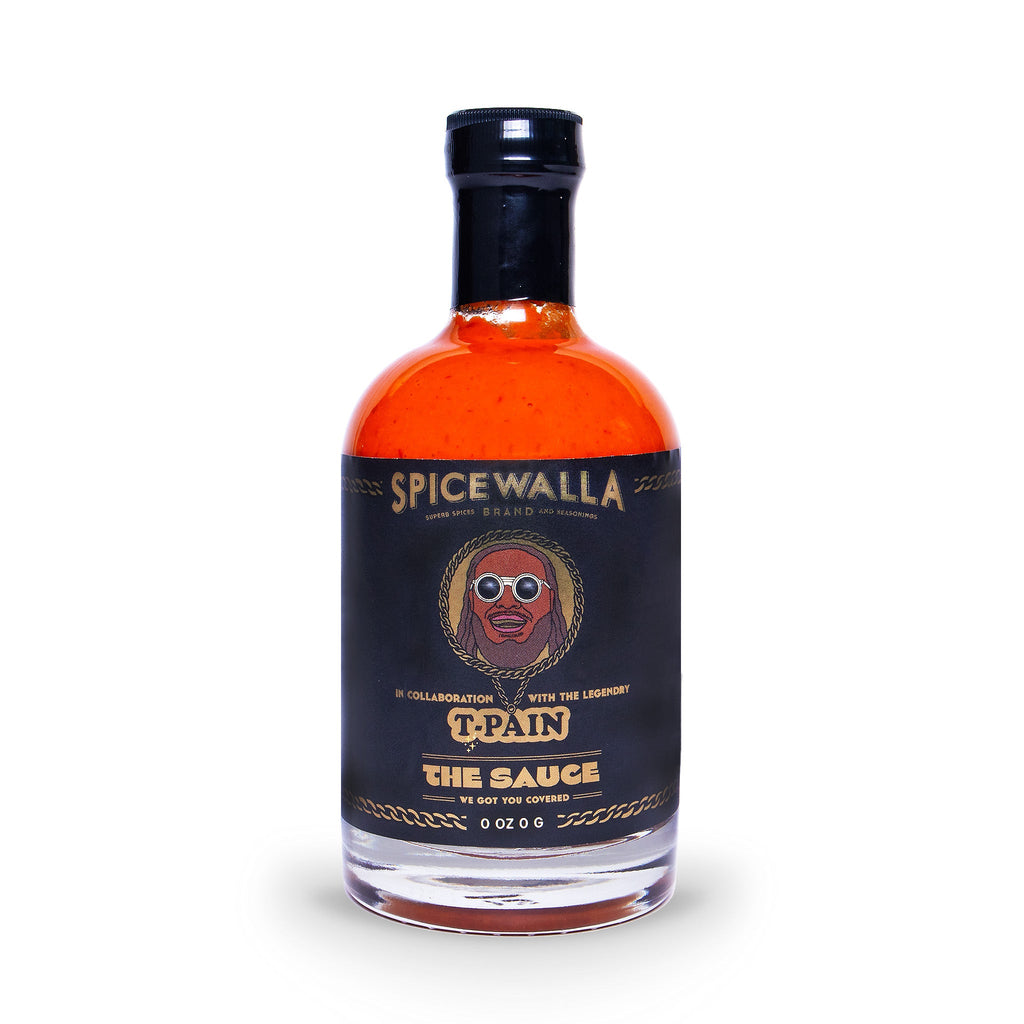 Spicewalla hot sauce bottle, front view with black label on orange glass.