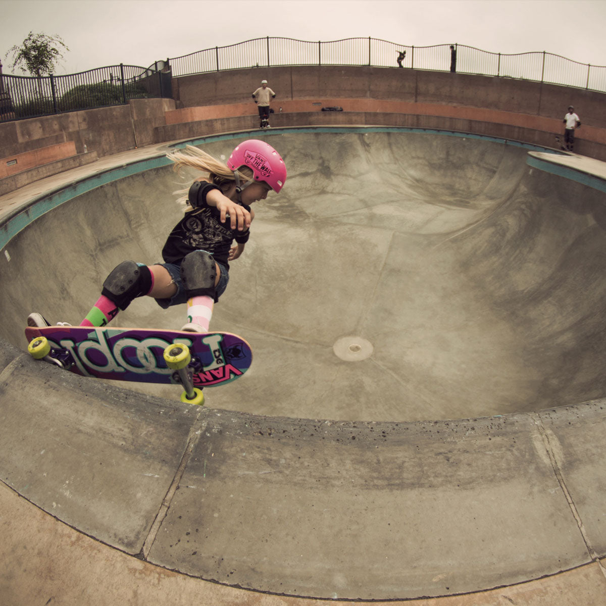 Skateboarder wearing black wrist, elbow, and knee protective pads