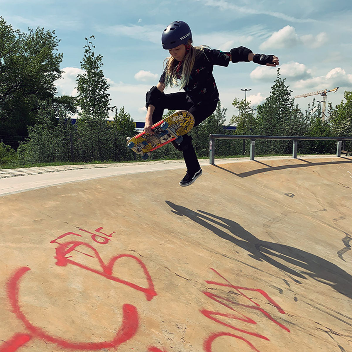 Skateboarder wearing black elbow, wrist, and knee protective pads