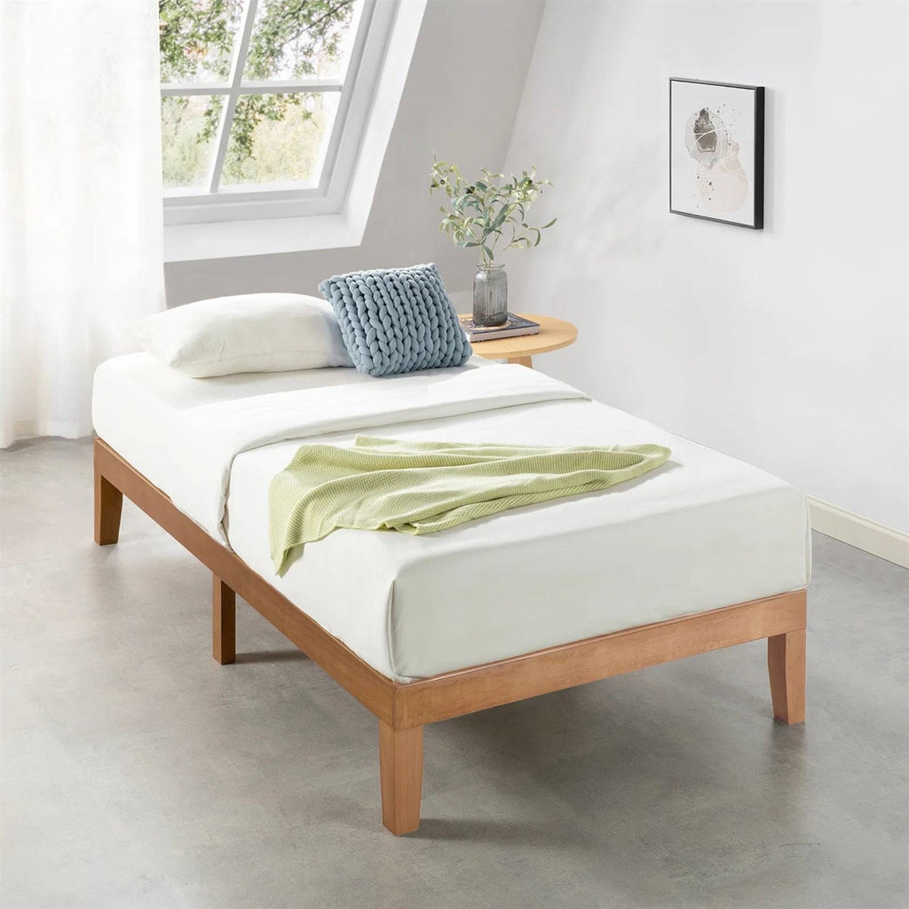 Twin platform bed frame in natural wood with white bedding and tapered legs